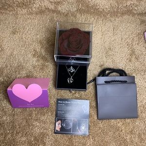 Real rose with necklace and ring